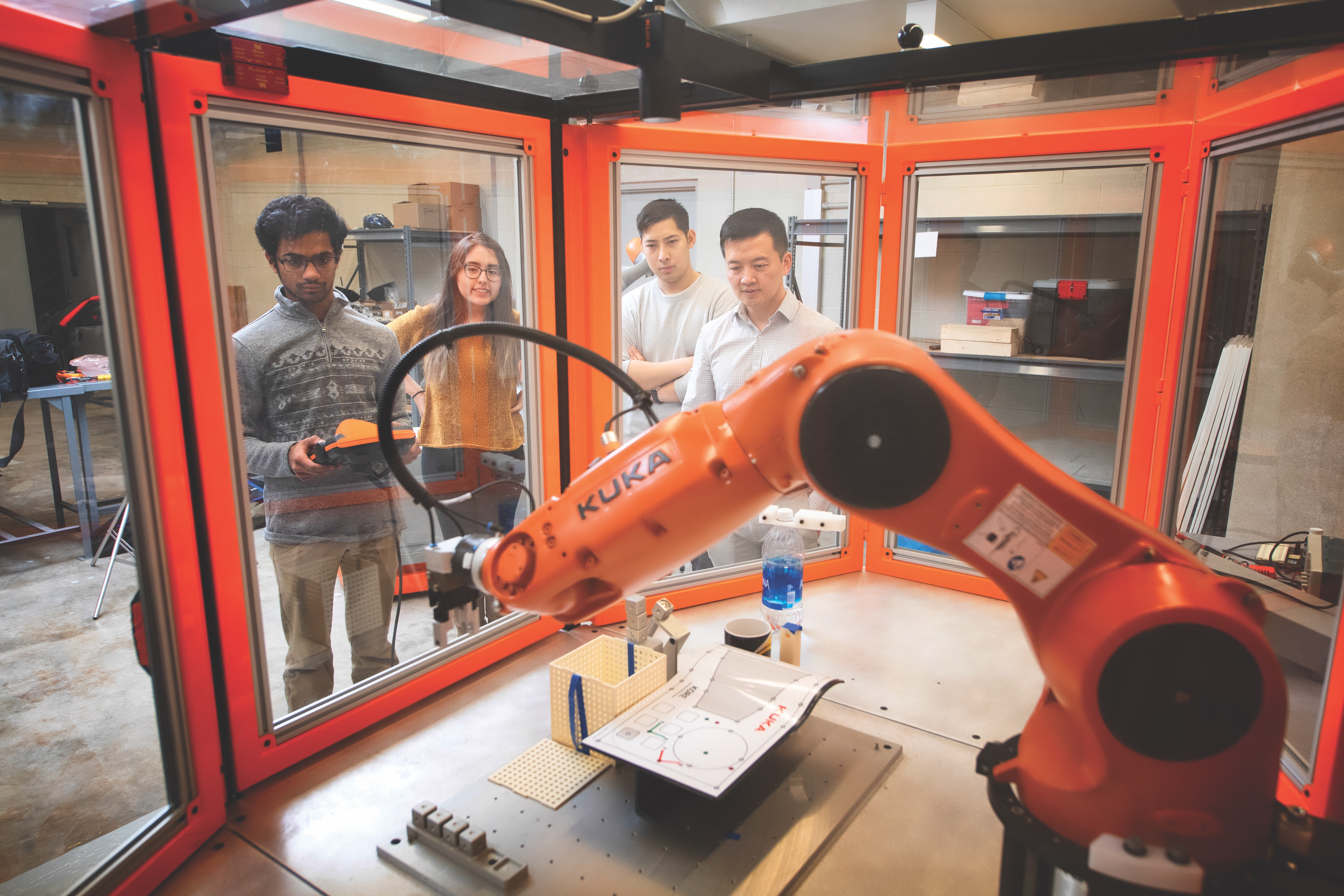 Mechanical Engineering students with robot arm